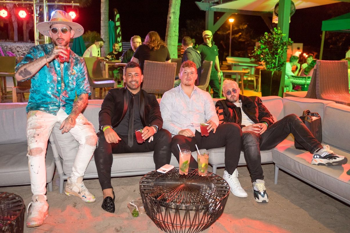 Guests relaxing together at an outdoor evening lounge
