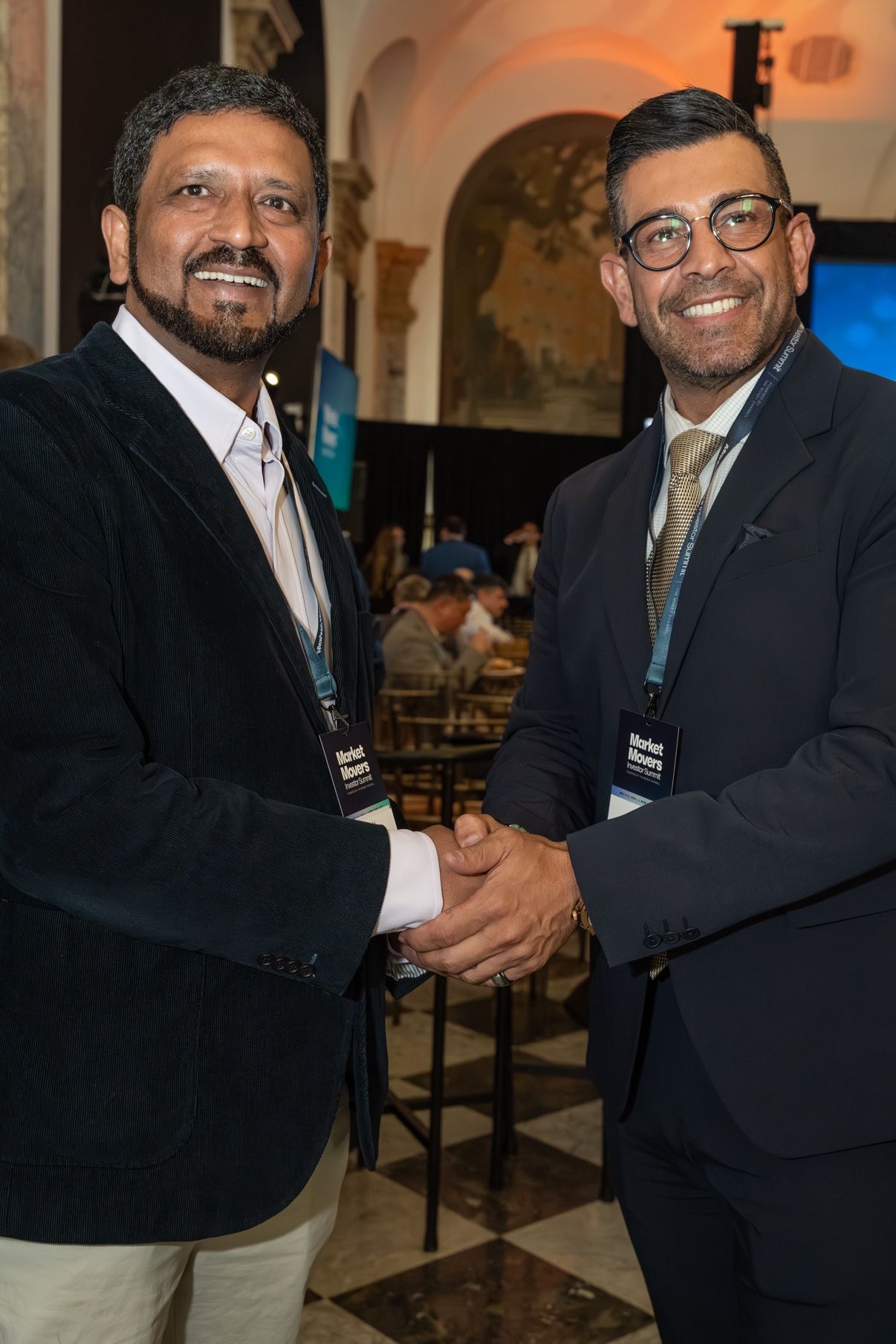 Two members shaking hands at an event