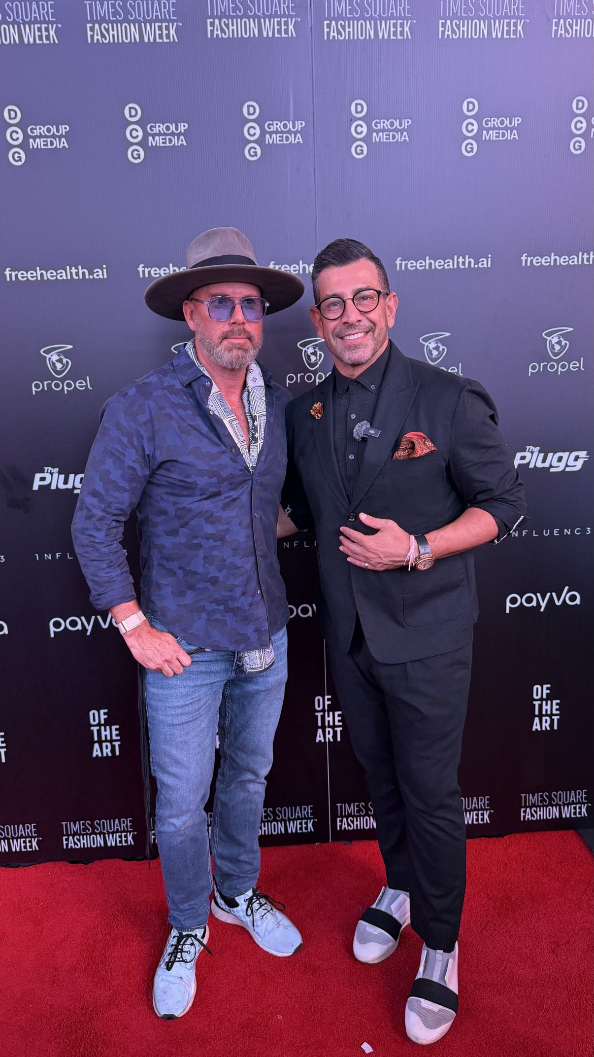 Guests posing on a red carpet